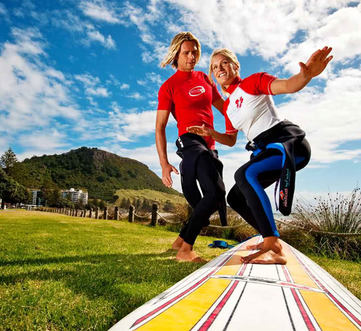 a surfing teacher instructing a student